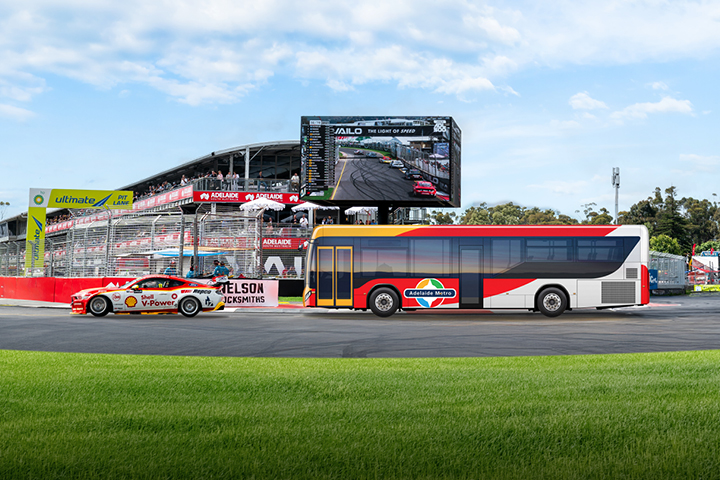 A V8 Supercar and Adelaide Metro bus driving on the Adelaide 500 track at Victoria Park